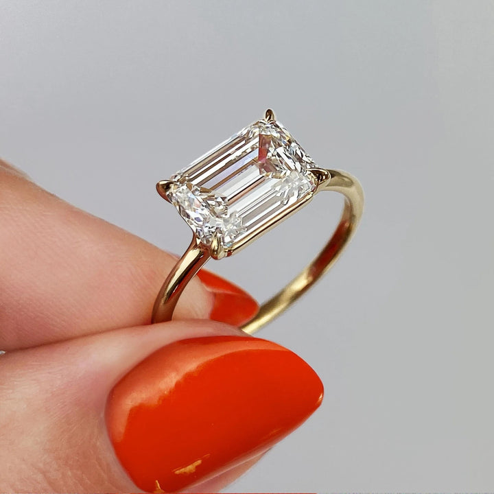 Emerald cut diamond ring worn on hand