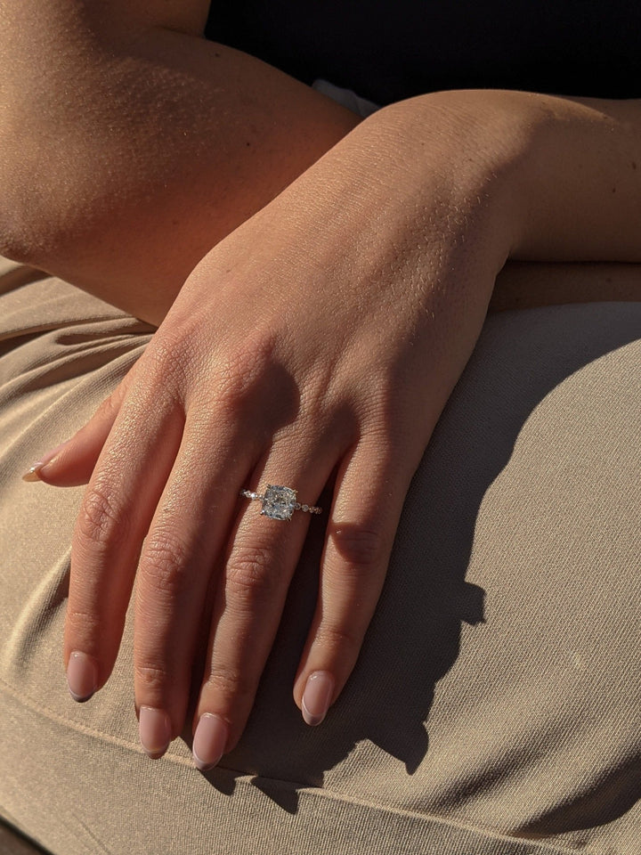 Cushion hidden halo engagement ring close-up highlighting diamond sparkle