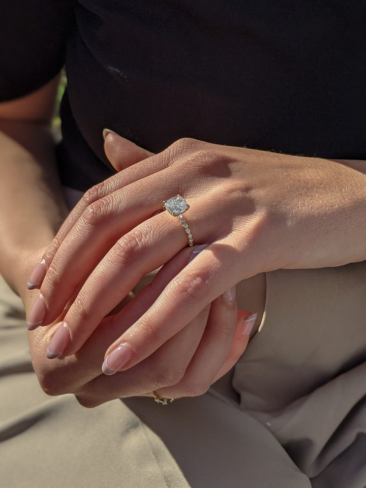 Close-up of cushion cut center diamond in hidden halo engagement ring