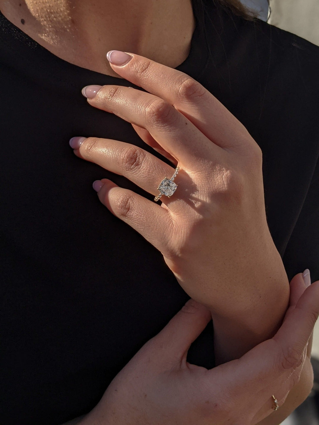 Macro shot of cushion cut diamond facets in hidden halo ring setting