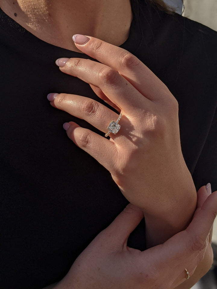 Macro shot of cushion cut diamond facets in hidden halo ring setting