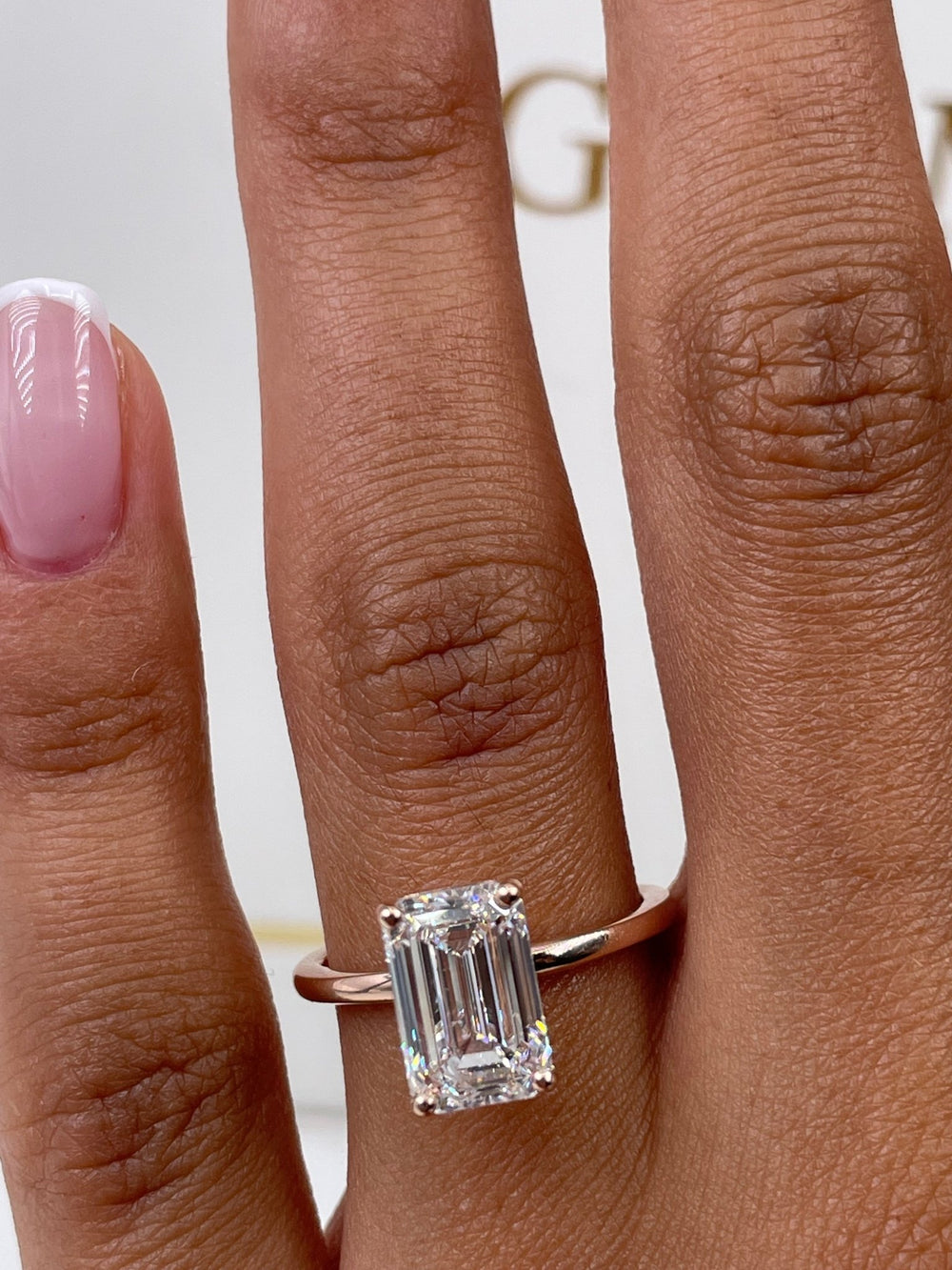 Close-up of emerald cut center diamond in solitaire engagement ring