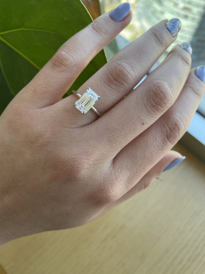 Emerald solitaire diamond ring presented in signature gift packaging