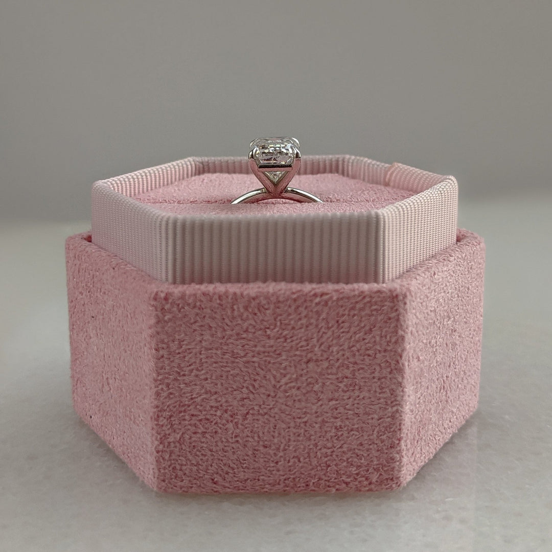 Emerald cut engagement ring shown with authenticity certificate