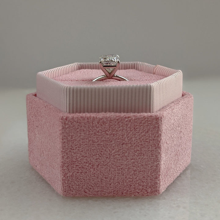 Emerald cut engagement ring shown with authenticity certificate