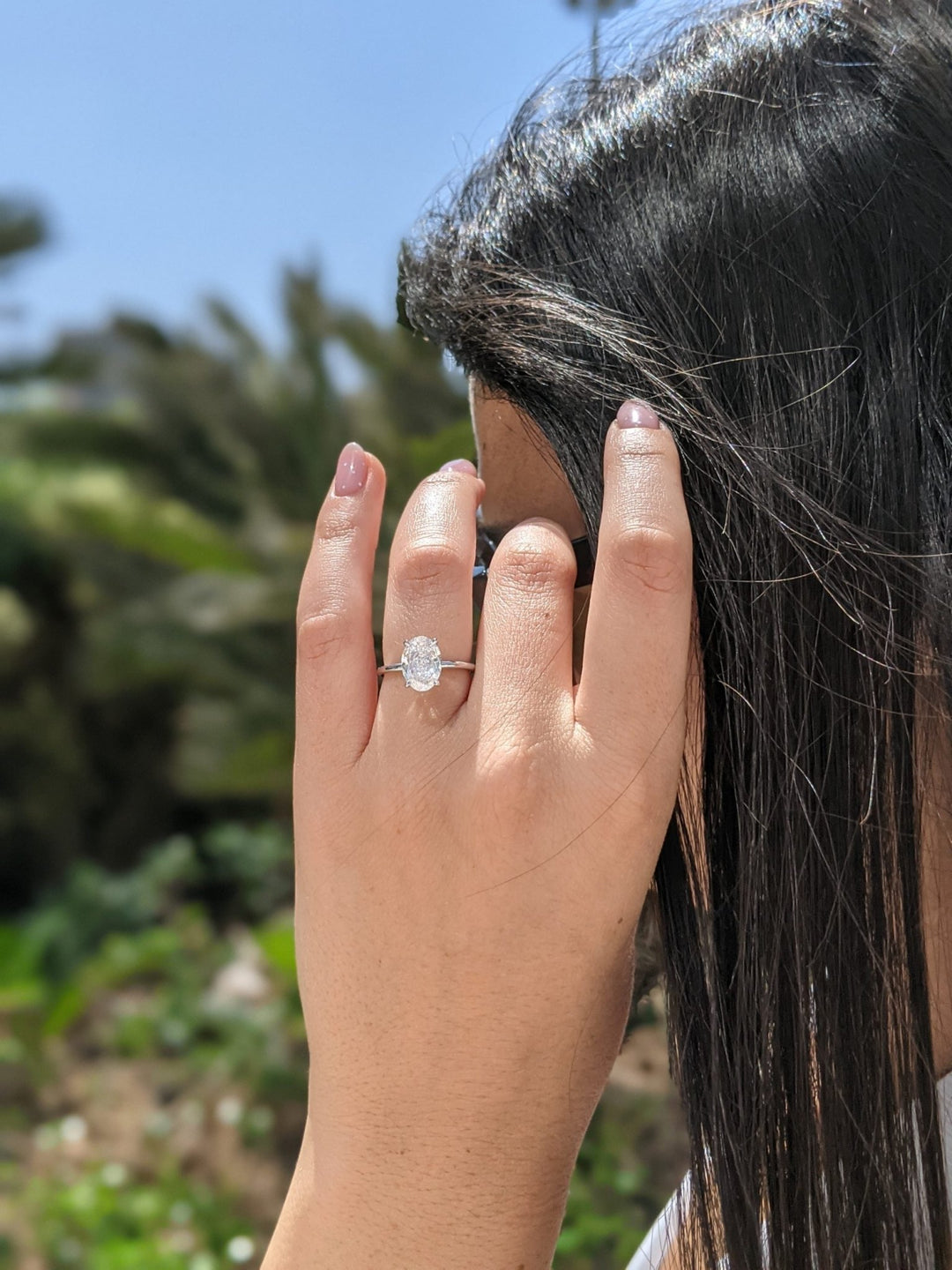 Oval cut solitaire engagement ring with IGI certified center diamond