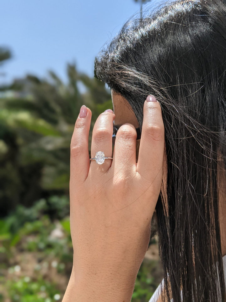 Oval cut solitaire engagement ring with IGI certified center diamond