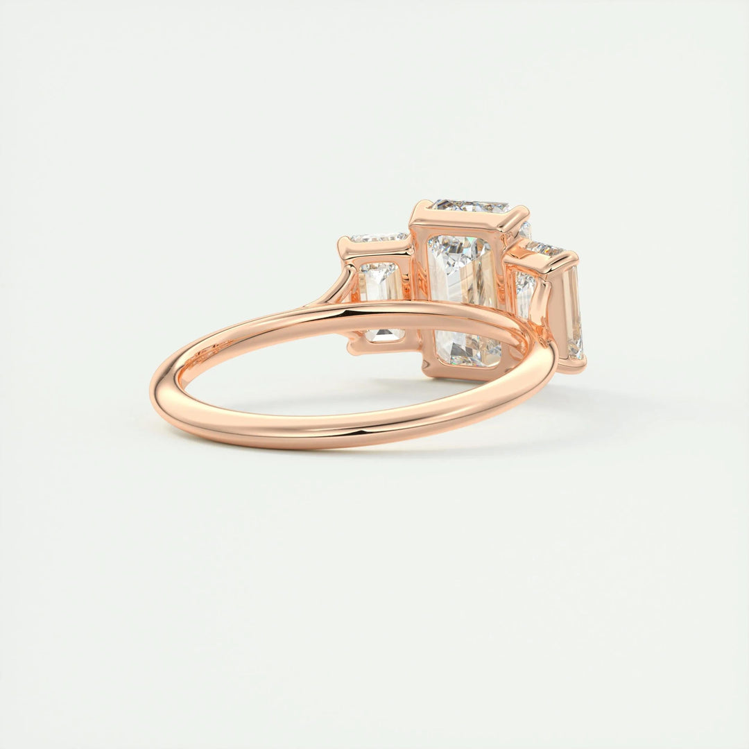 Emerald cut three stone engagement ring shown in real-life wear