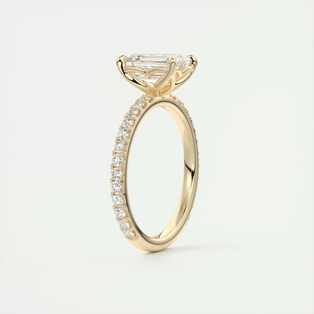 Emerald pave diamond ring displayed on jewelry stand