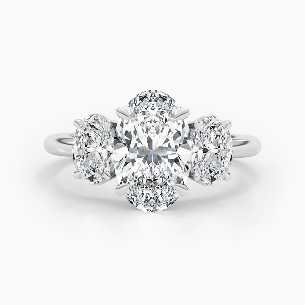 Oval three stone diamond ring displayed on jewelry stand
