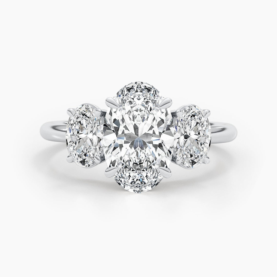 Oval three stone diamond ring displayed on jewelry stand