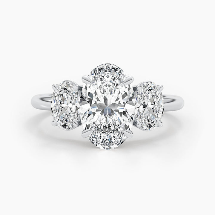 Oval three stone diamond ring displayed on jewelry stand