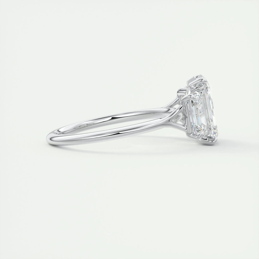 Angled view of emerald cut diamond in three stone setting