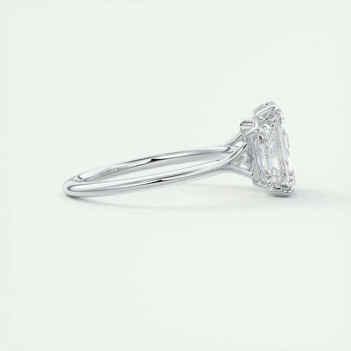 Angled view of emerald cut diamond in three stone setting