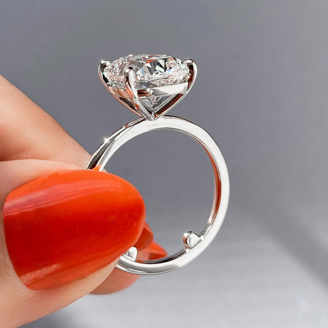 Cushion solitaire engagement ring offered in gold and platinum