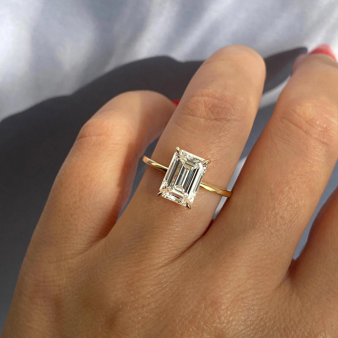 IGI certified emerald cut diamond in solitaire engagement ring setting
