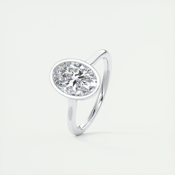 Oval bezel engagement ring shown on hand for true-to-life sizing