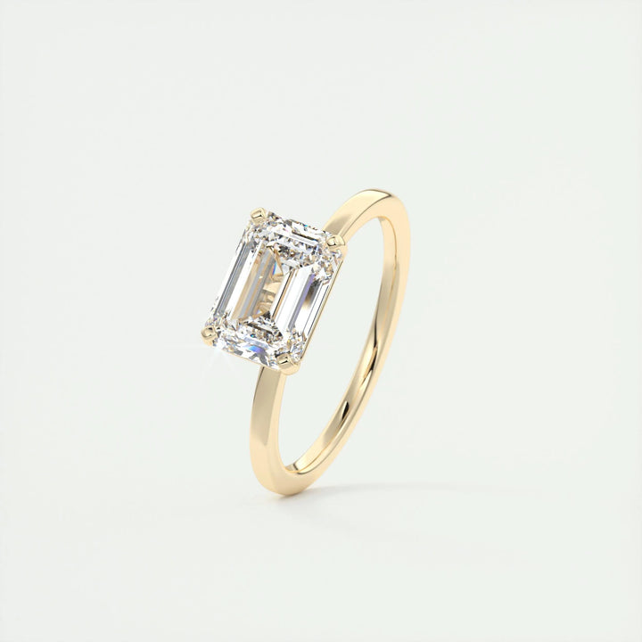Emerald east west diamond engagement ring available in multiple metals