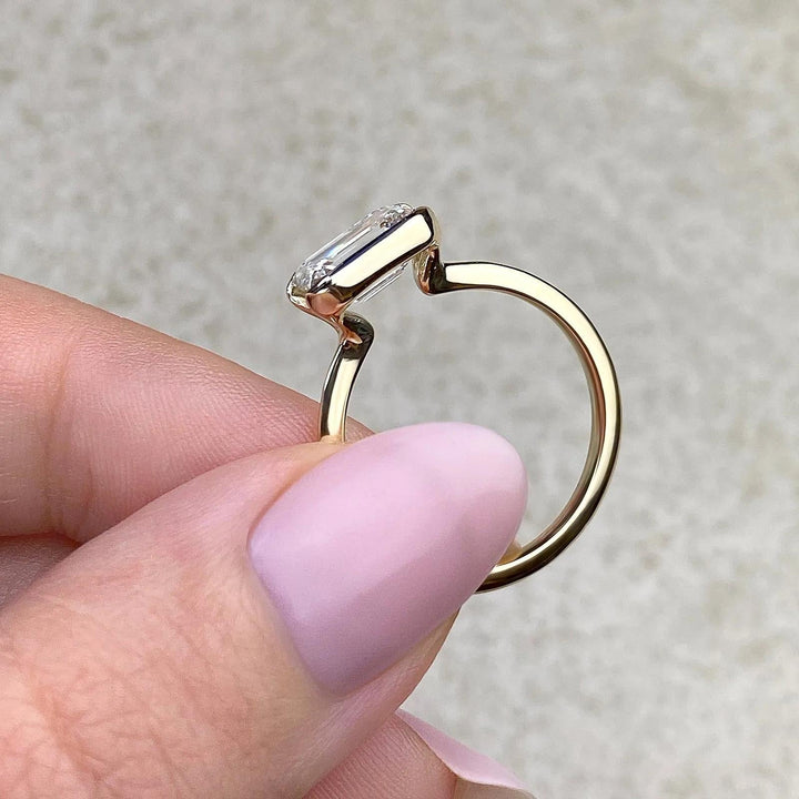 Emerald solitaire lab grown diamond ring fitted on finger