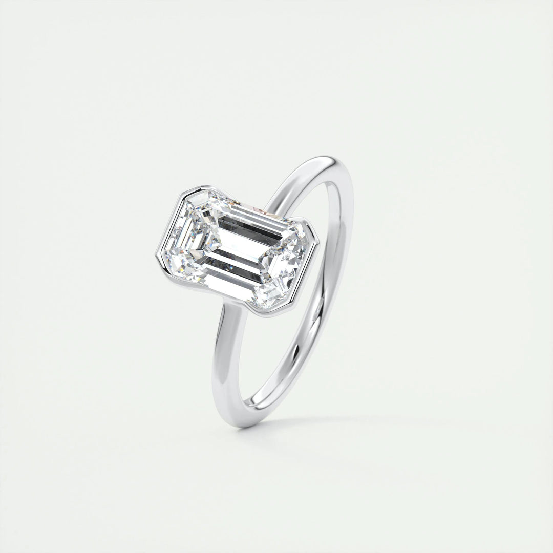 Emerald solitaire engagement ring photographed in natural light