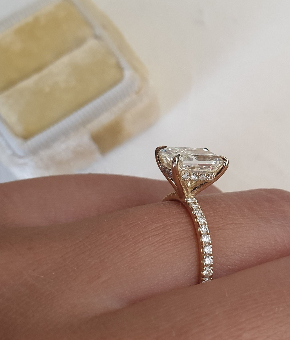 Close-up of radiant cut center diamond in pave engagement ring