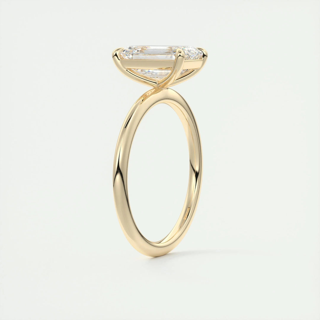 Side angle of emerald solitaire diamond engagement ring