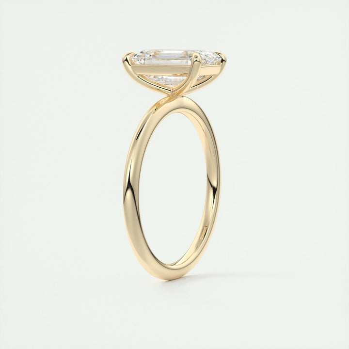 Side angle of emerald solitaire diamond engagement ring