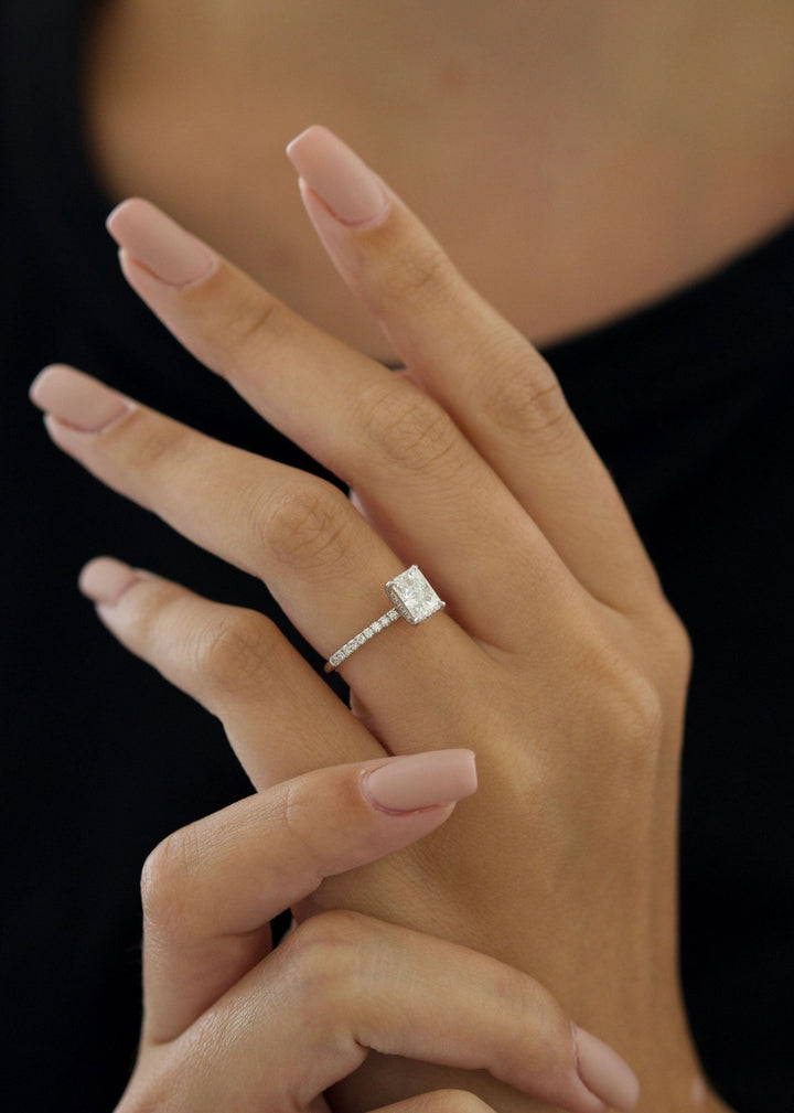 Close-up of radiant cut center diamond in pave engagement ring