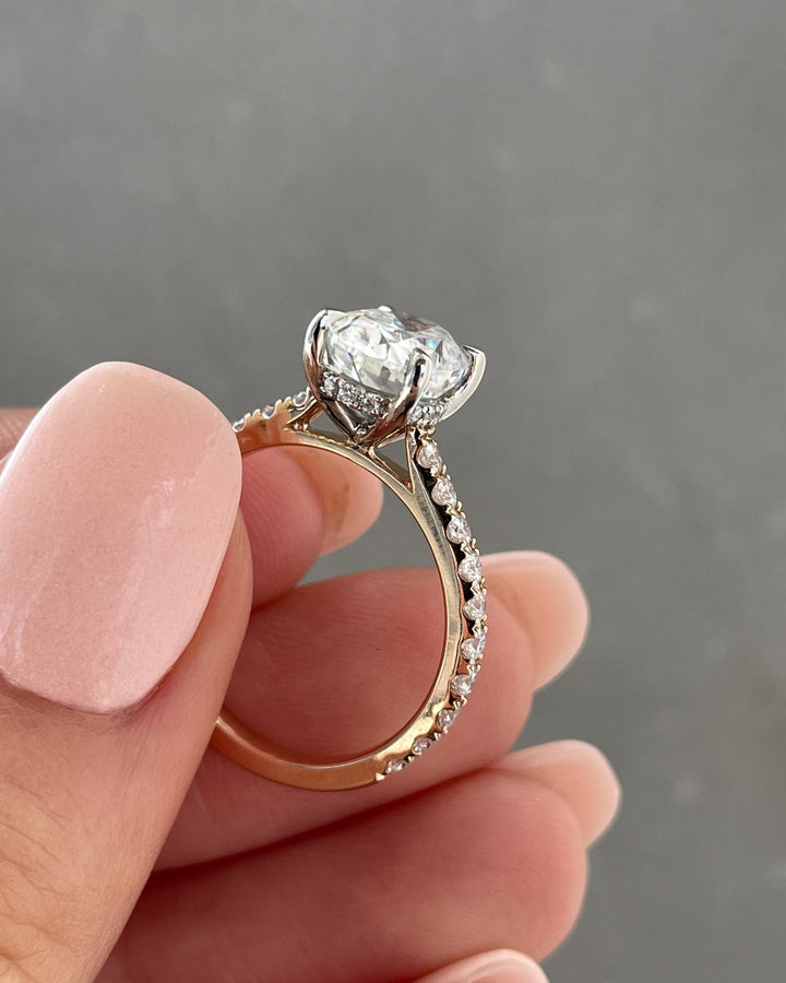 Fine craftsmanship detail on oval hidden halo engagement ring