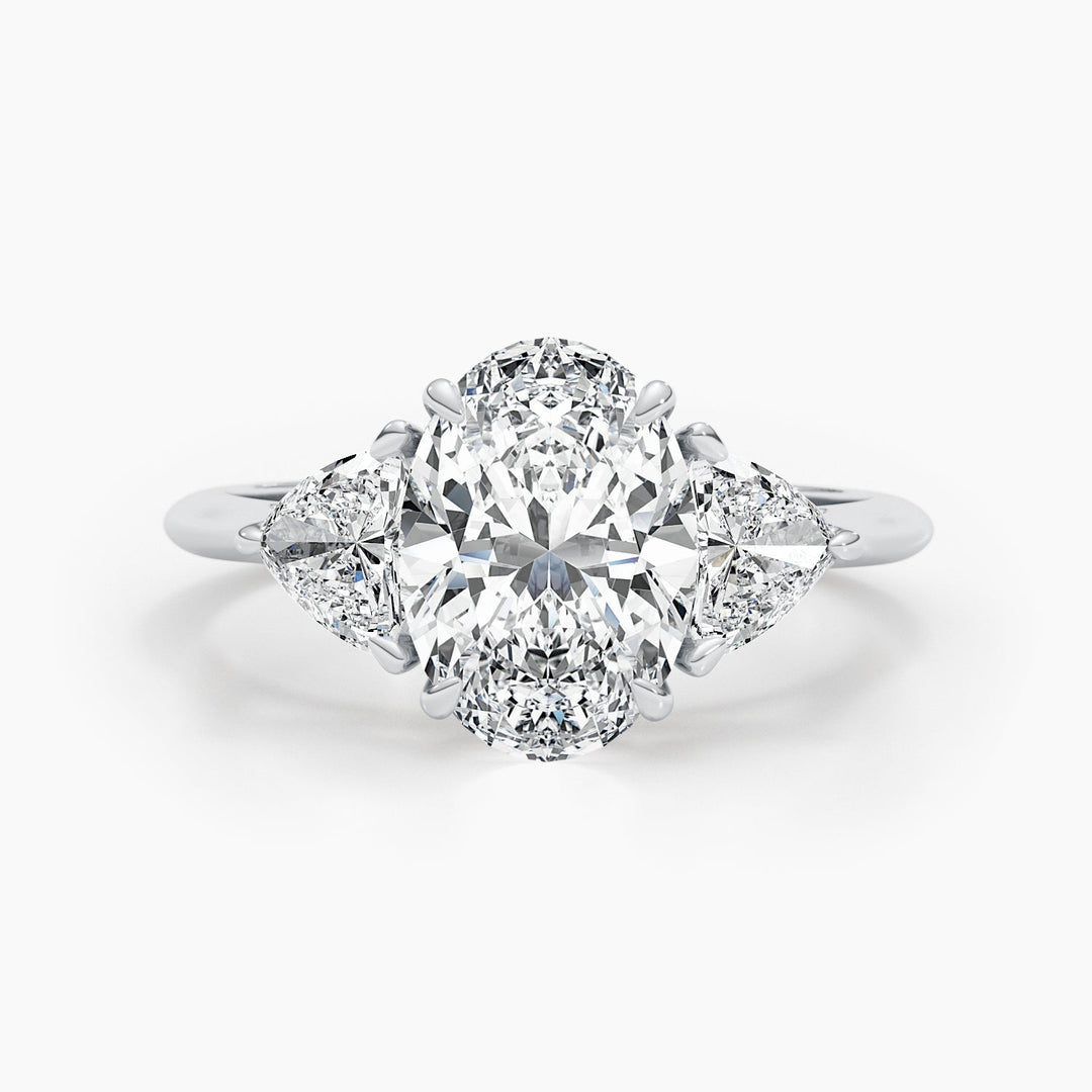 Oval cut three stone engagement ring shown in real-life wear