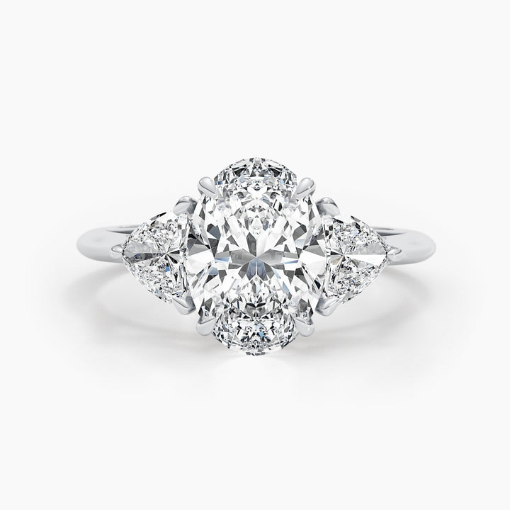 Oval cut three stone engagement ring shown in real-life wear