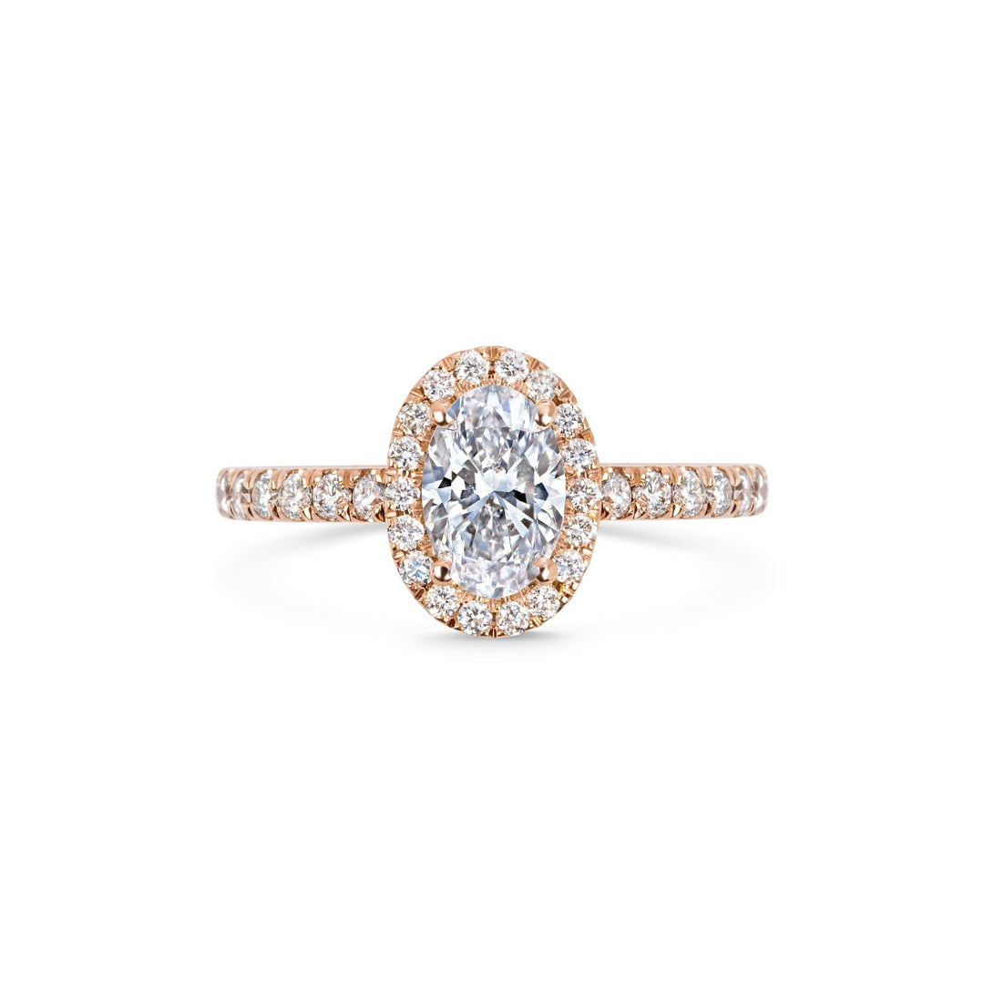 Close-up of oval cut center diamond in pave engagement ring