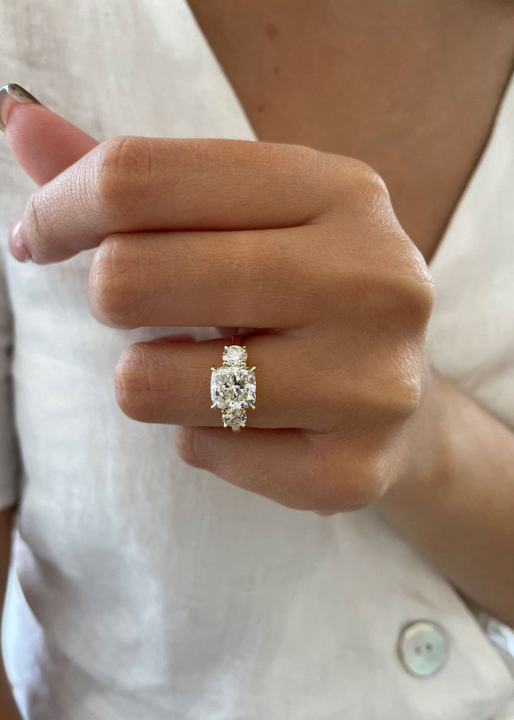 Premium cushion cut three stone engagement ring crafted in solid gold