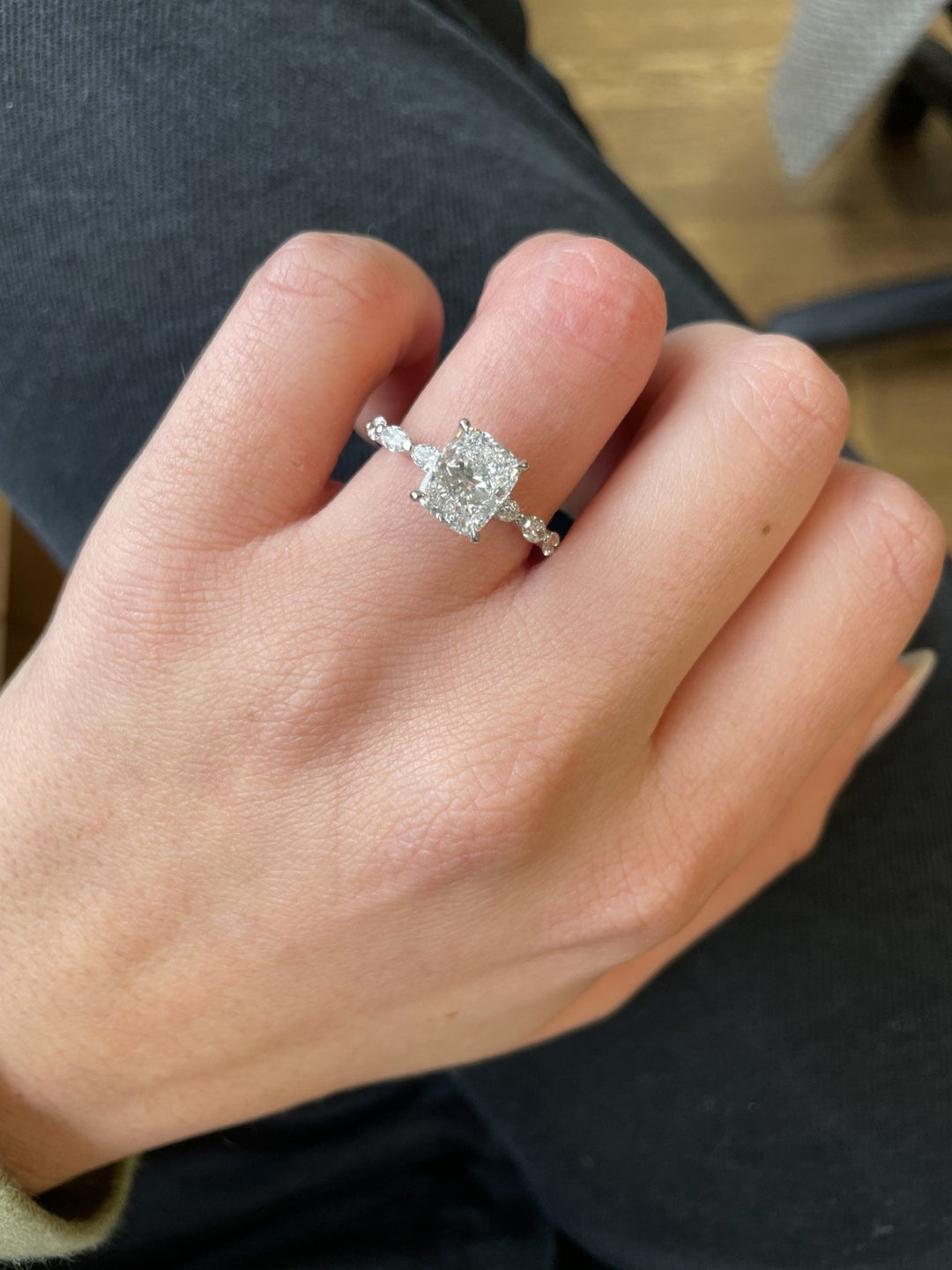 Cushion cut engagement ring shown with authenticity certificate