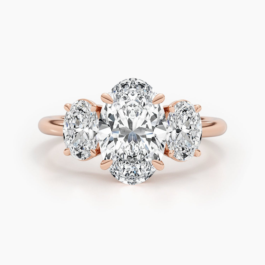 Close-up of oval cut center diamond in three stone engagement ring