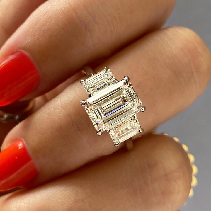 Emerald three stone engagement ring offered in gold and platinum