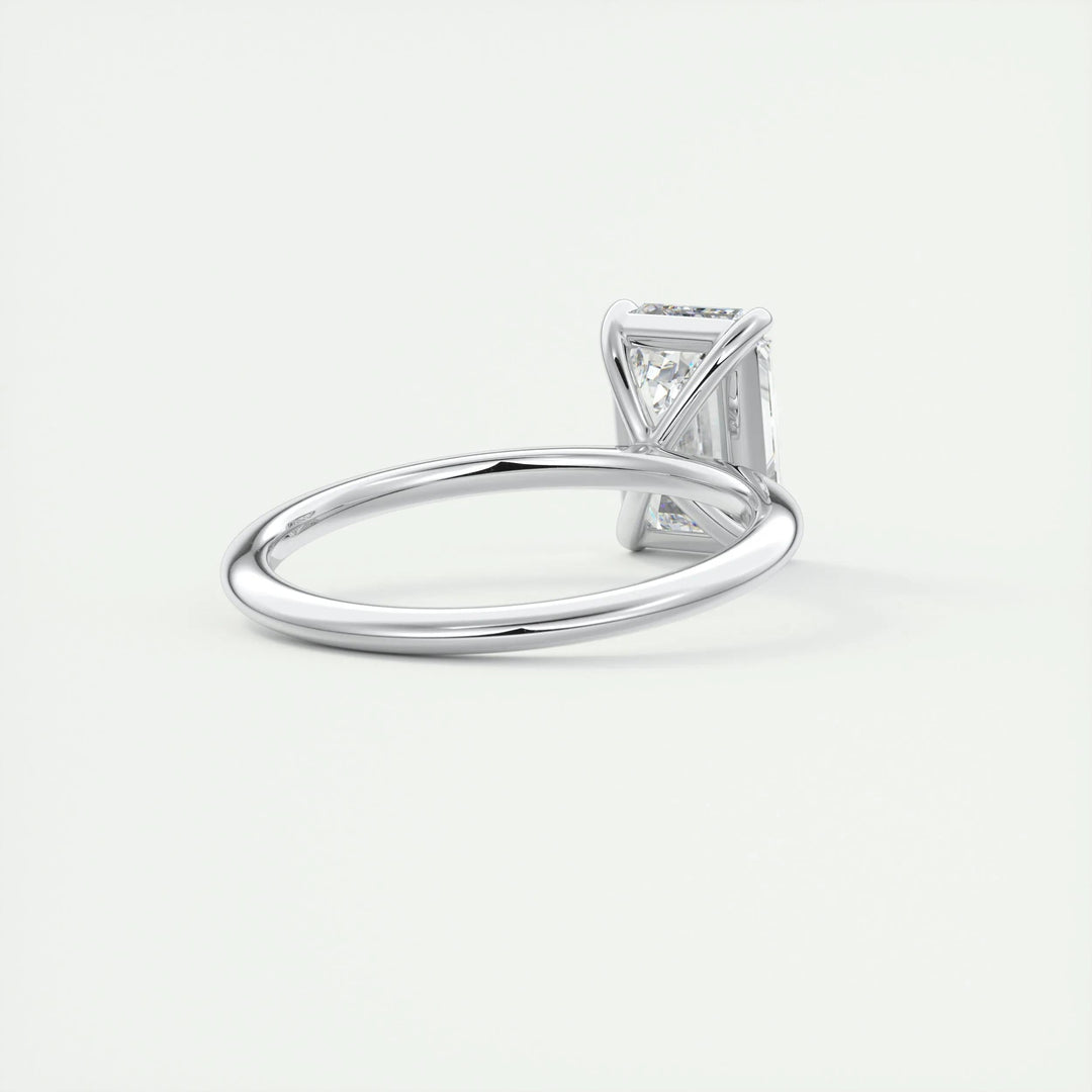 Emerald solitaire engagement ring close-up showing F-/VS1 diamond clarity