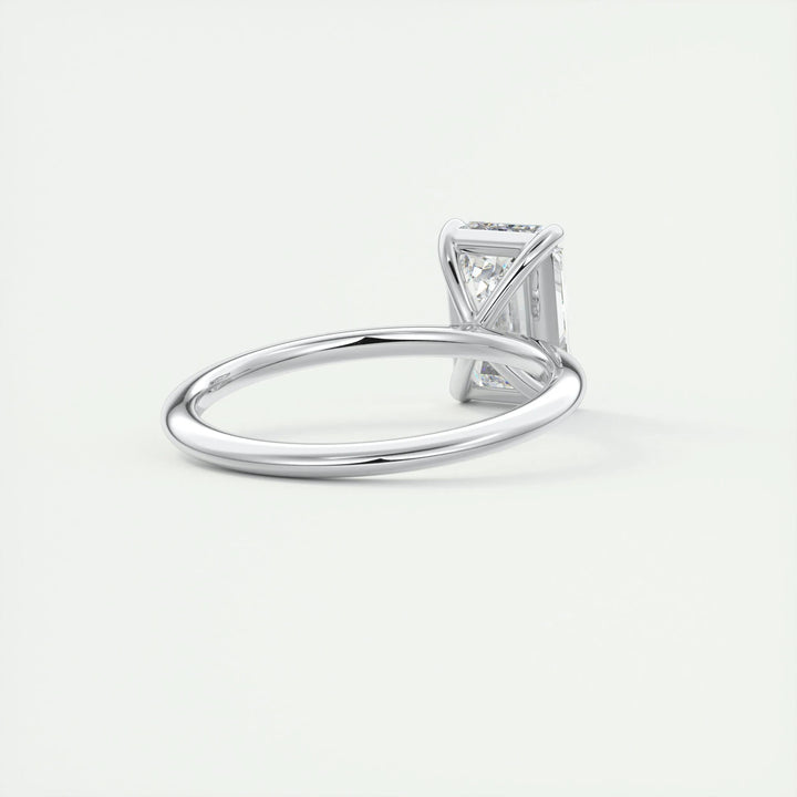 Emerald solitaire engagement ring close-up showing F-/VS1 diamond clarity