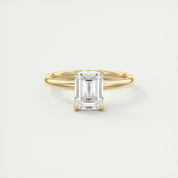 Emerald solitaire engagement ring viewed from the side