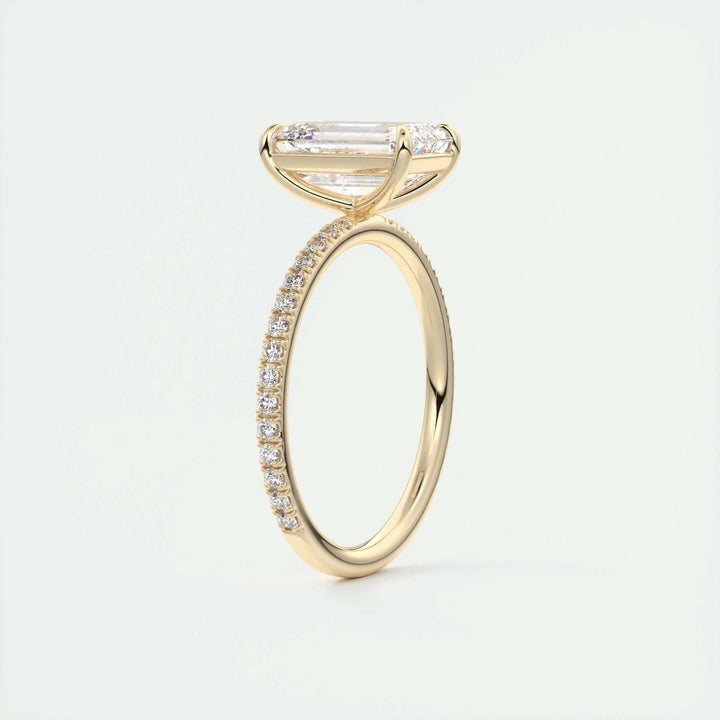 Angled view of emerald cut diamond in pave setting