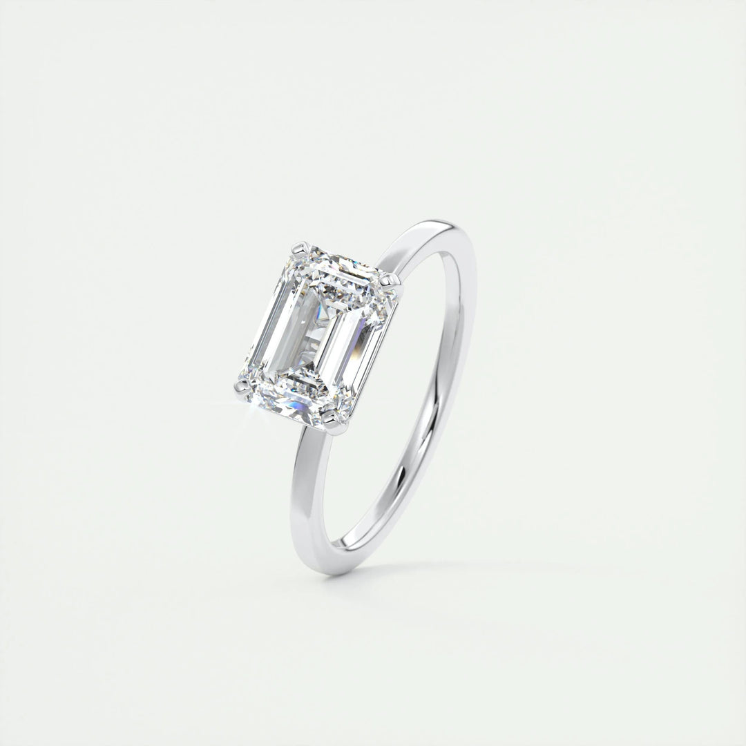 Lifestyle shot of emerald east west diamond ring on hand