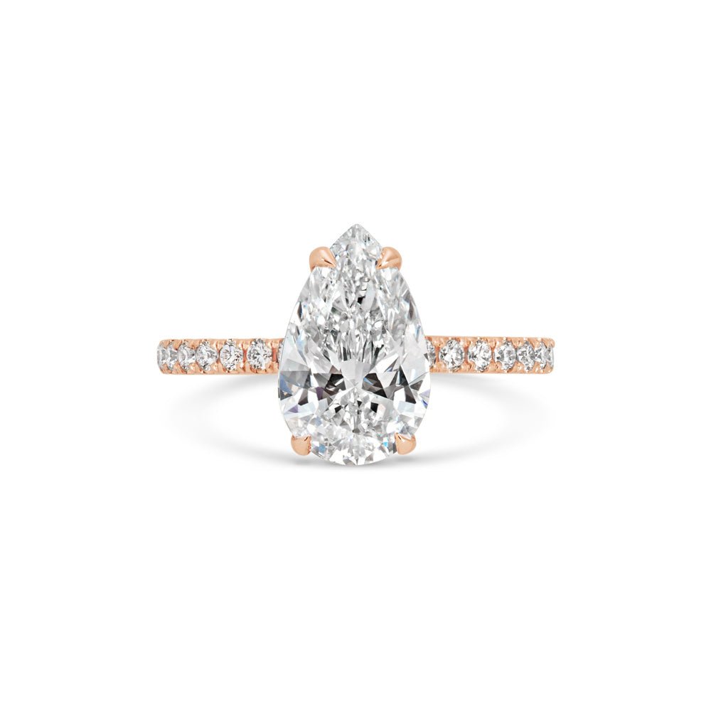 Angled view of pear cut diamond in pave setting