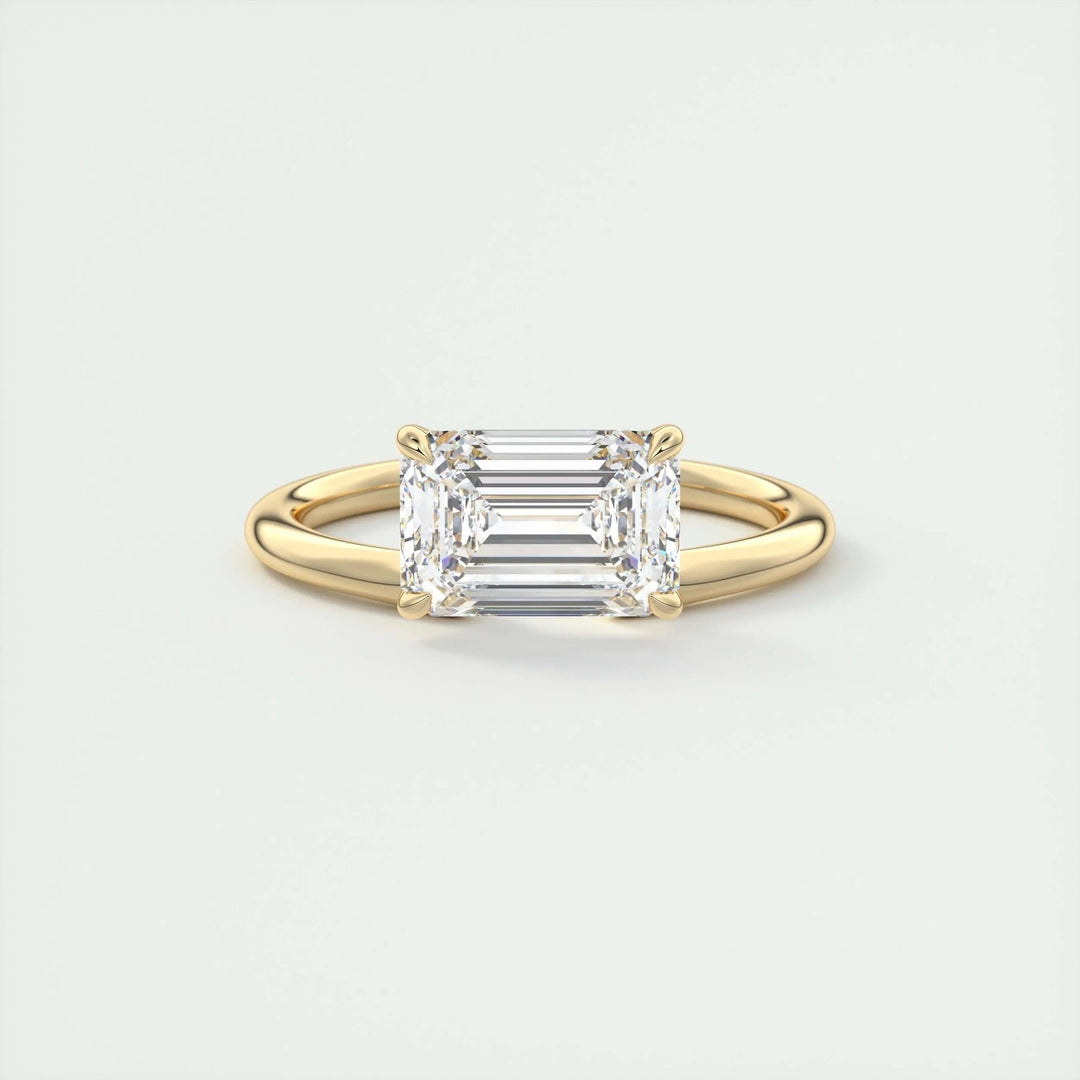 Emerald solitaire engagement ring viewed from the side