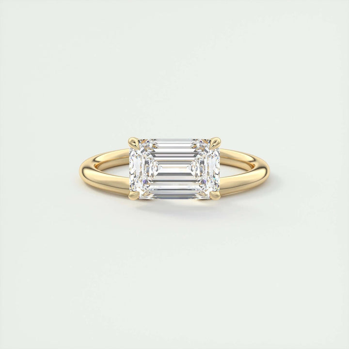 Emerald solitaire engagement ring viewed from the side