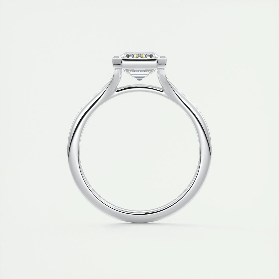 Emerald bezel engagement ring shown on hand for true-to-life sizing