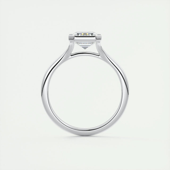 Emerald bezel engagement ring shown on hand for true-to-life sizing