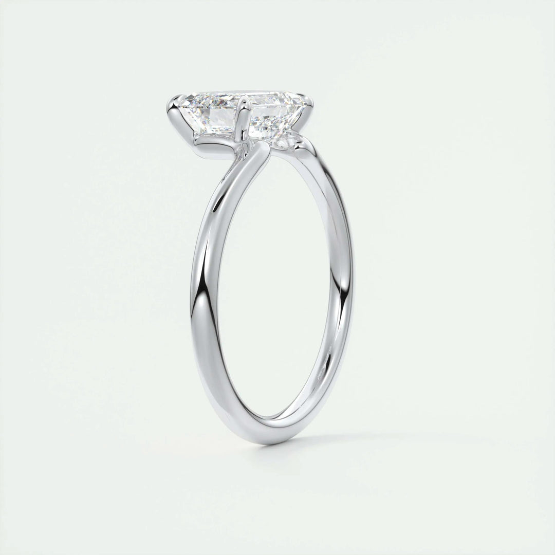 Side angle of emerald solitaire diamond engagement ring