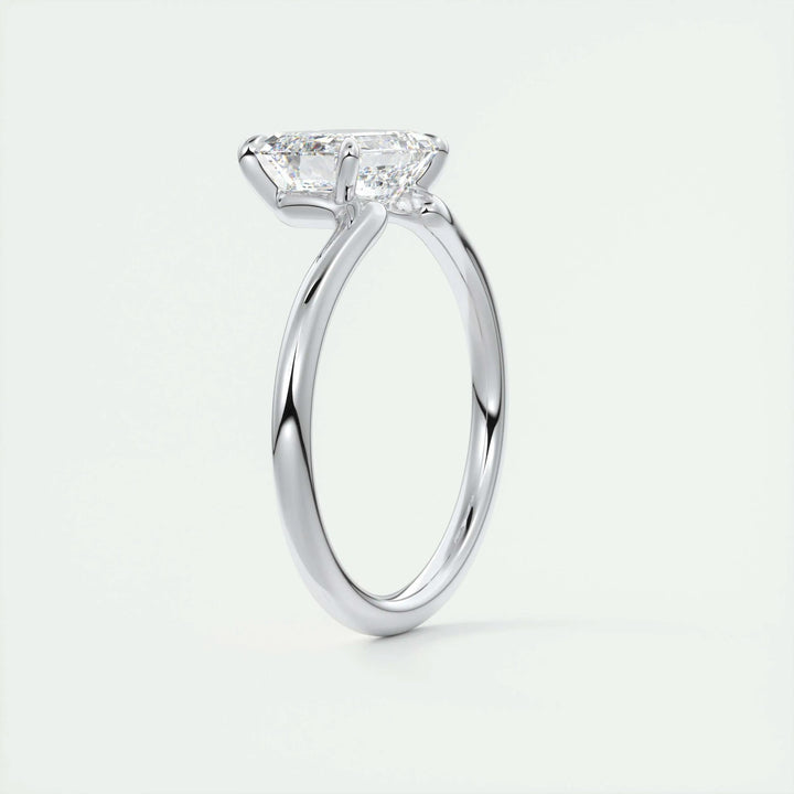 Side angle of emerald solitaire diamond engagement ring
