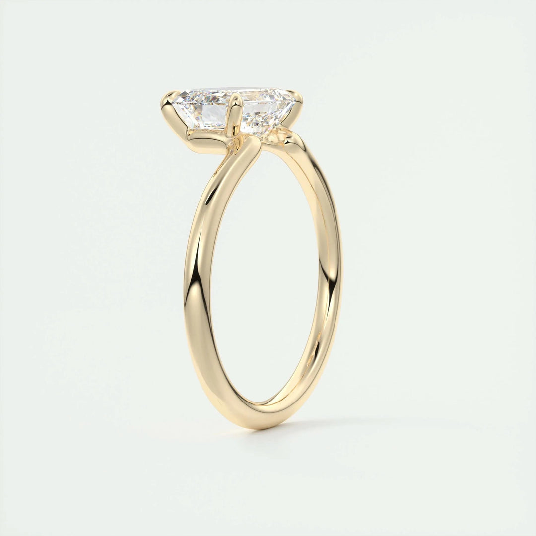 Lifestyle shot of emerald solitaire diamond ring on hand