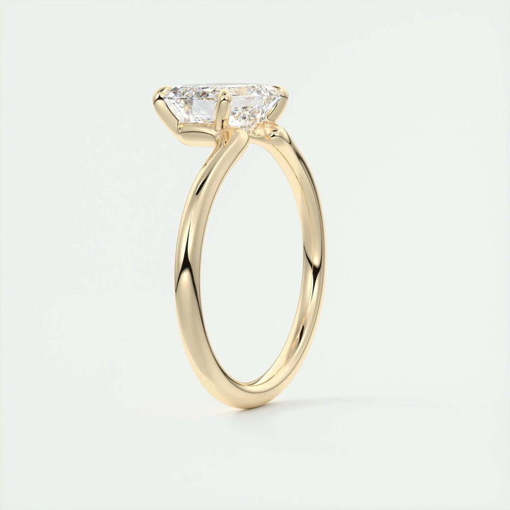 Lifestyle shot of emerald solitaire diamond ring on hand